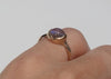 side view of 14k gold blue moonstone ring with carved arrow details on hand
