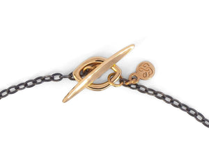 gold toggle clasp and logo tag on black chain