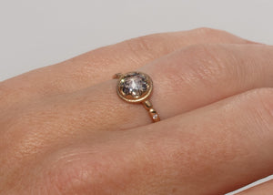 gold alternative engagement ring with claw set rose cut salt and pepper diamond on hand