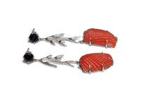 Coral and black stone earrings on a white background