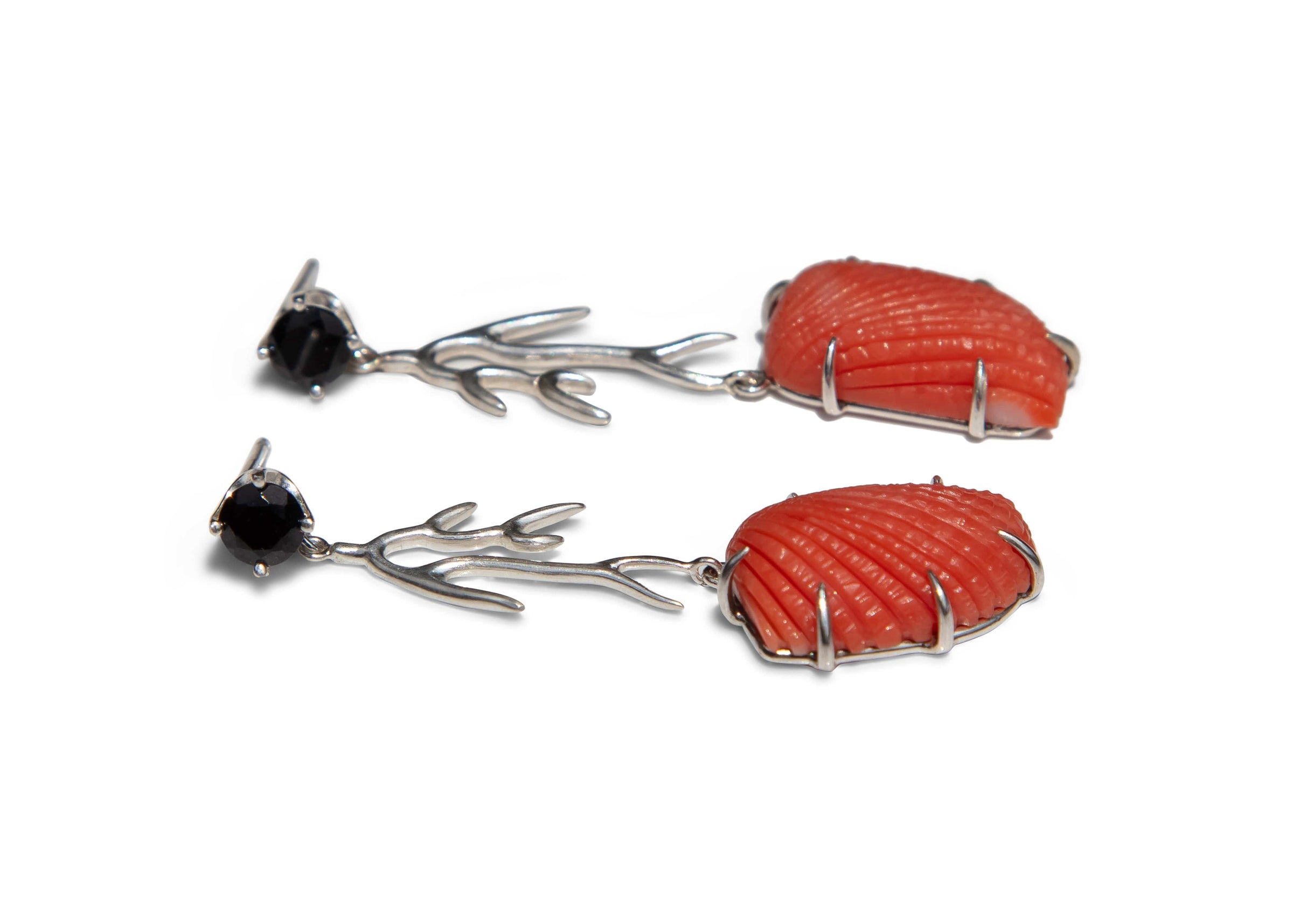 Coral and black stone earrings on a white background