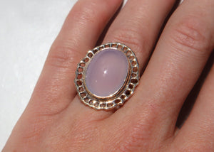 14k gold cocktail ring with cutout sea fan motif around blue chalcedony stone in center on hand