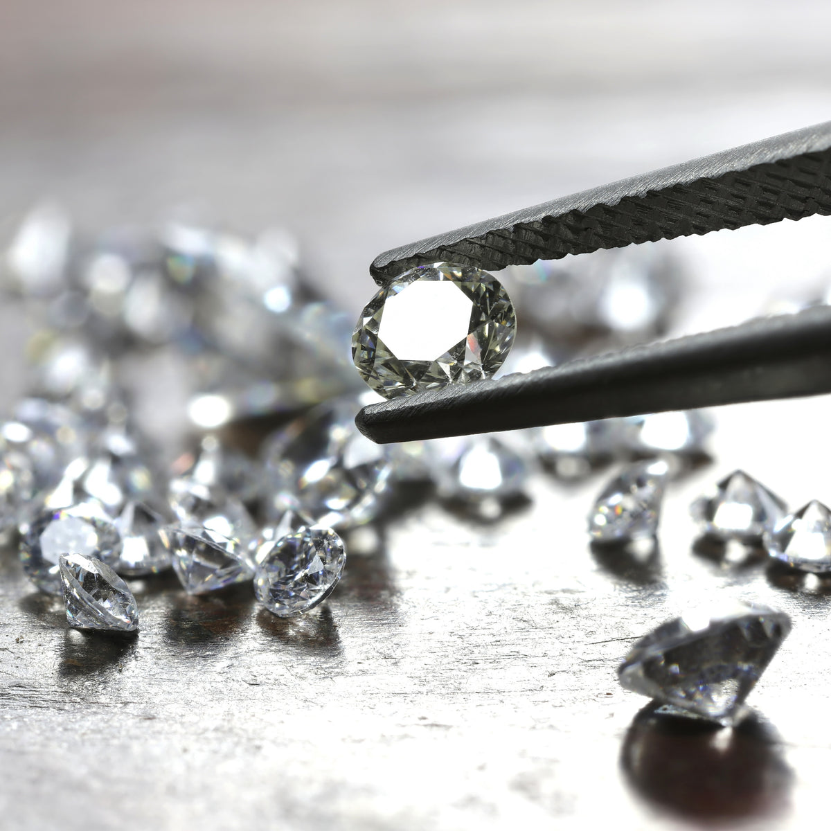 lab grown diamonds in tweezers