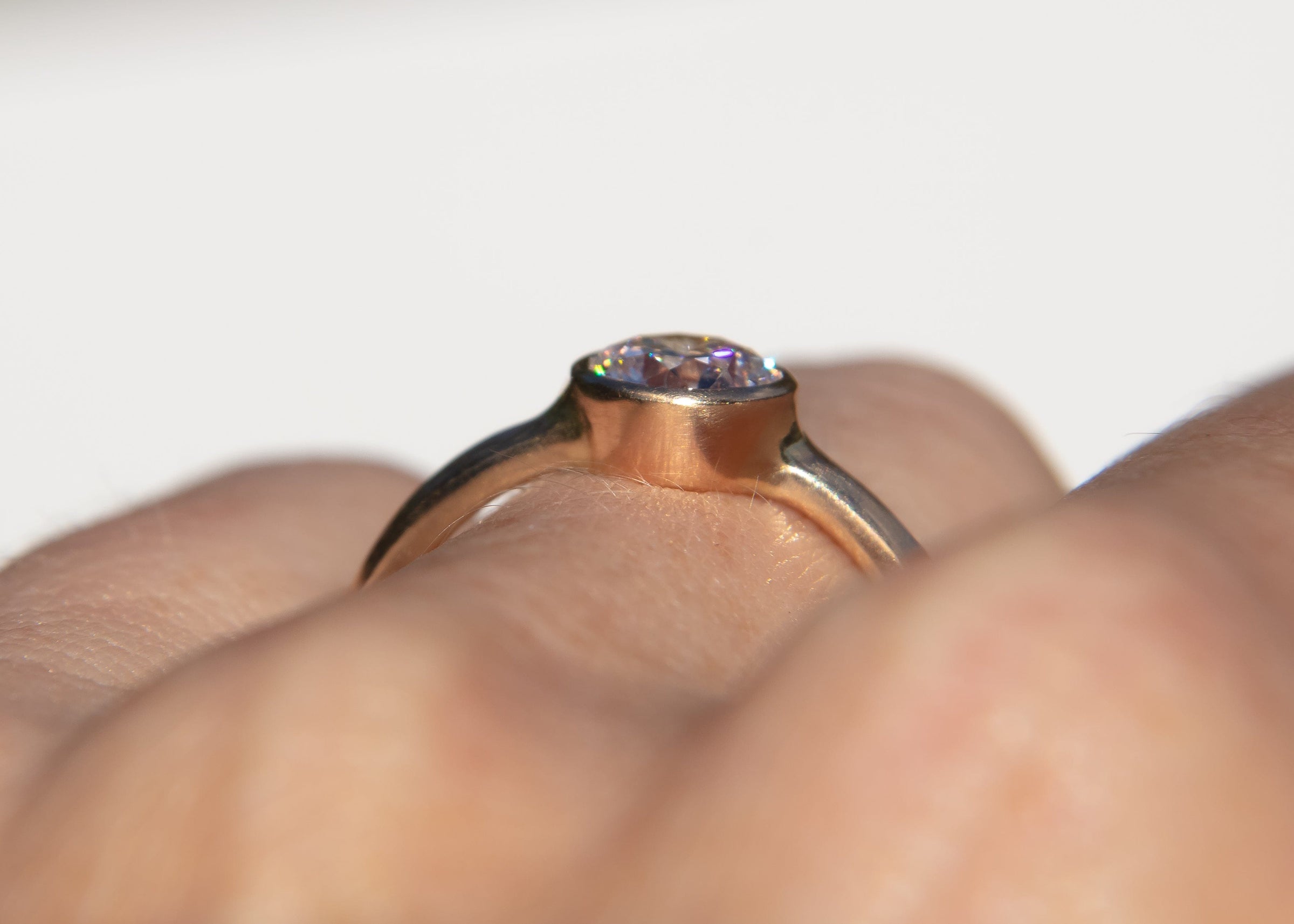 gold wave ring with diamond in low profile setting on hand