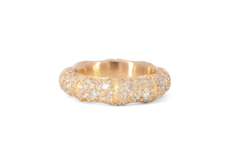 Gold bamboo ring with pave set diamonds on a white background