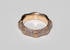 Gold bamboo ring with pave set diamonds on a light gray background