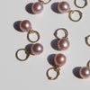 14k gold lavender pearl charms on a light background