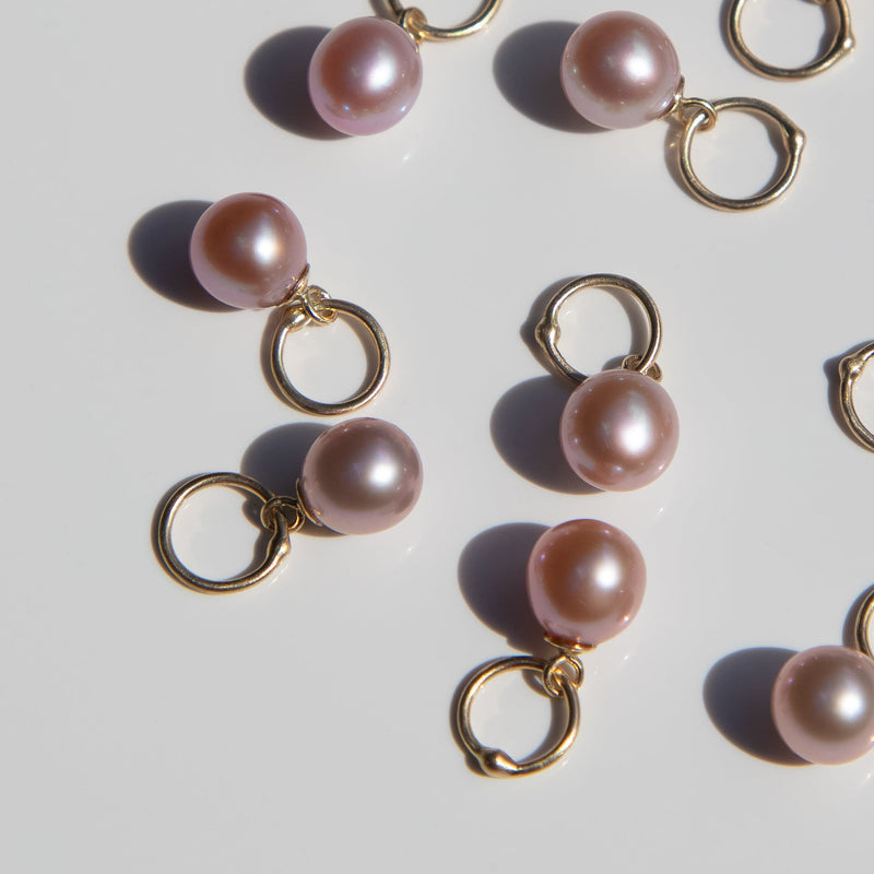 14k gold lavender pearl charms on a light background