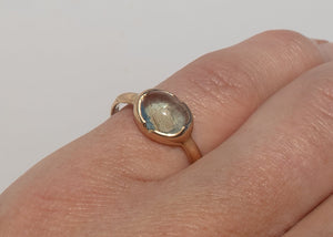 14k gold moss aquamarine ring with carved arrows and diamonds on hand
