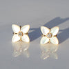 gold mother of pearl flower earrings with diamonds