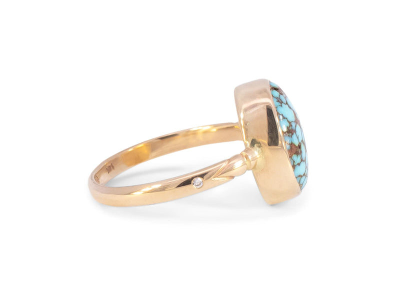 side of solid 14k gold turquoise ring with carved details on band