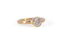 gold wave engagement ring with diamond on white background