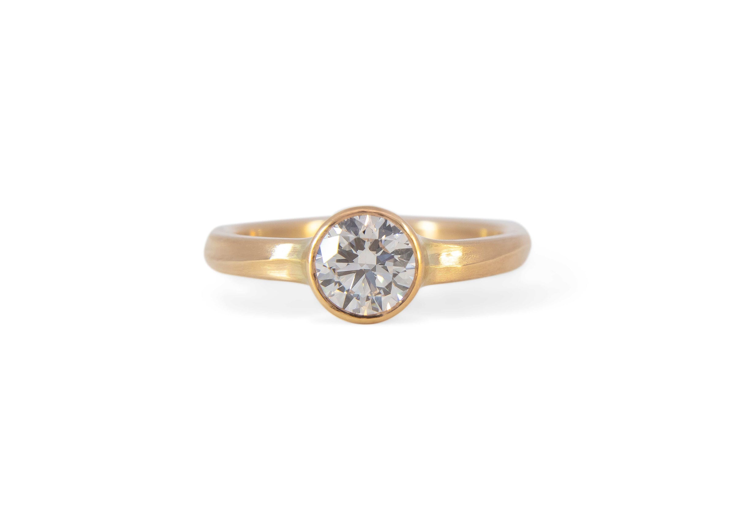 Gold wave ring with a diamond on a white background