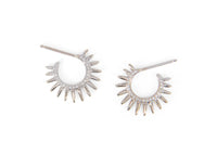 Pair of spiky silver hoop earrings with diamonds on a white background