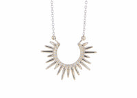 spiky white gold necklace with diamonds on a white background