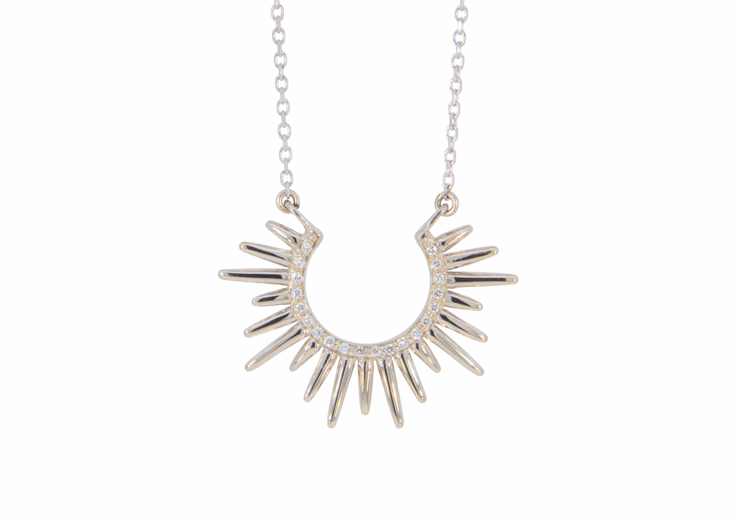 spiky white gold necklace with diamonds on a white background