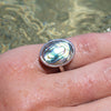 sterling silver oval abalone shell ring on wet hand