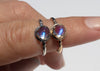 antique inspired rings with bullet shaped blue moonstones in scalloped setting on hand
