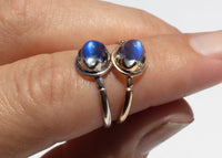 antique inspired rings with bullet shaped blue moonstones in scalloped setting on hand
