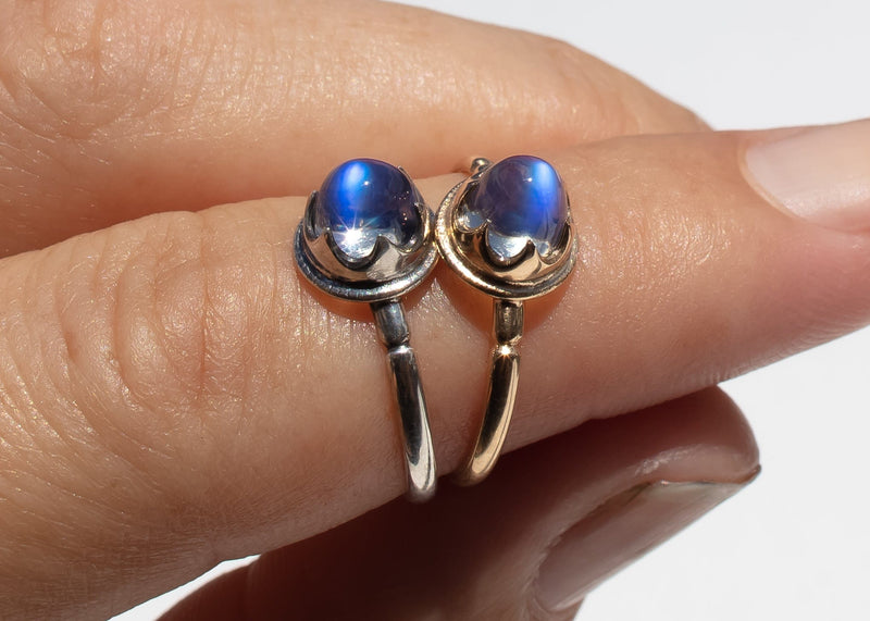 antique inspired rings with bullet shaped blue moonstones in scalloped setting on hand
