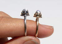 antique inspired rings with bullet shaped blue moonstones in scalloped setting on hand