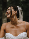 white stick pearl dangly cascade earrings on bride
