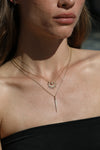 spiky gold necklaces with diamonds on model