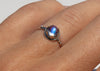 oxidized sterling silverantique inspired ring with bullet shaped blue moonstone in scalloped setting on hand