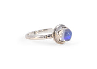 side of silver antique inspired ring with blue moonstone in scalloped setting