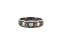 oxidized sterling silver urchin shell inspired ring with inverted blue zircon stones