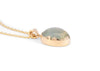 side of 14k gold green moonstone necklace with scalloped bezel