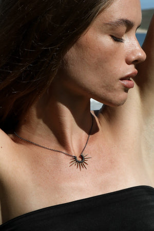 sea urchin necklace with gold powder coated spikes and black chain on model
