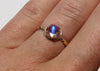 14k gold antique inspired ring with bullet shaped blue moonstone in scalloped setting on hand