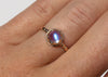 antique inspired ring with blue moonstone in scalloped setting on hand