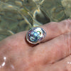 sterling silver oval abalone shell ring on hand underwater
