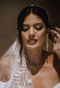 white dangly stick pearl cascade earrings on bride