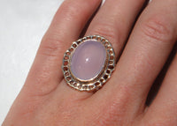 14k gold cocktail ring with cutout sea fan motif around blue chalcedony stone on hand