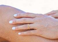 gold seaweed ring on hand