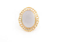 14k gold cocktail ring with cutout sea fan motif around blue chalcedony stone in center