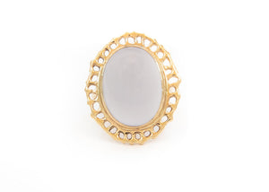 14k gold cocktail ring with cutout sea fan motif around blue chalcedony stone in center