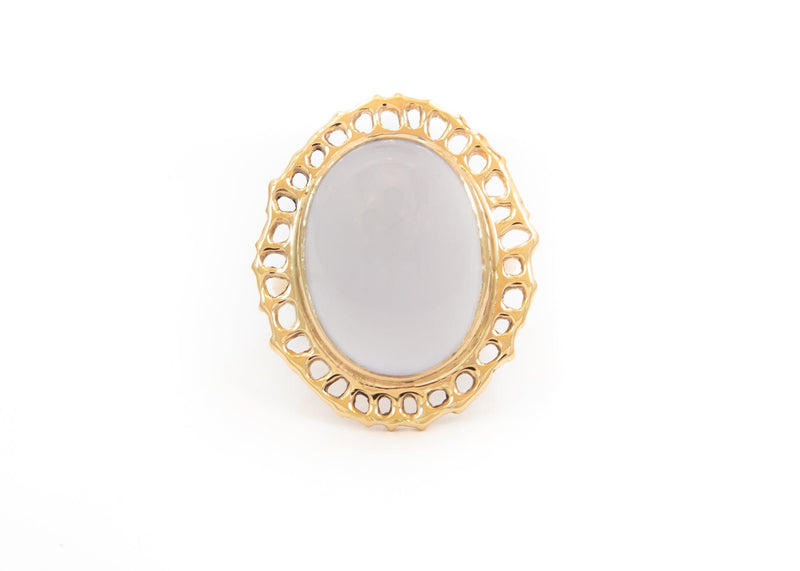 14k gold cocktail ring with cutout sea fan motif around blue chalcedony stone in center on hand