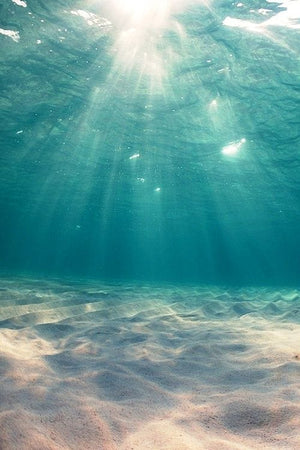 clear turquoise ocean water with sunlight rays