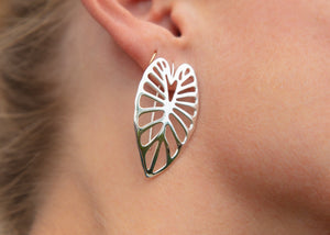 sterling silver kalo taro leaf earrings on model's ear