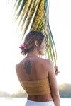 model with pink flowers in hair wearing spiky blue sea urchin inspired earrings