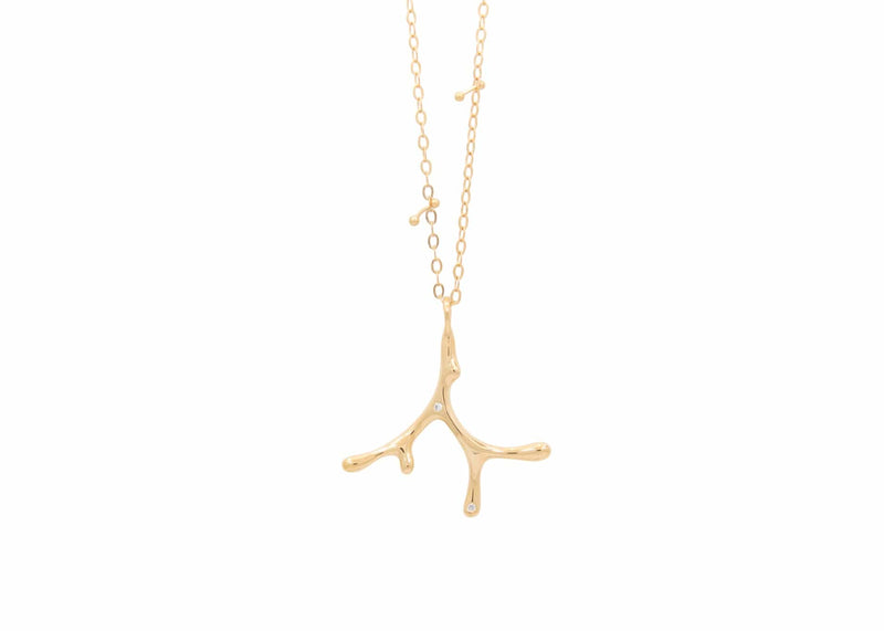 gold seaweed necklace with diamonds on chain with barbell details