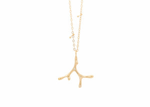 gold seaweed necklace with diamonds on chain with barbell details