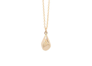 faceted gold teardrop shaped pendant on chain