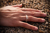 sterling silver rockweed seaweed ring on hand model in sand