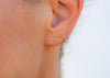 14k gold seaweed stud earrings on ear