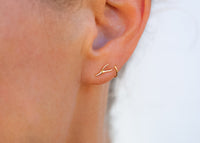 14k gold seaweed stud earrings on ear